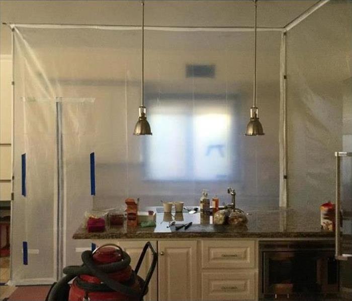 Kitchen with plastic containment walls