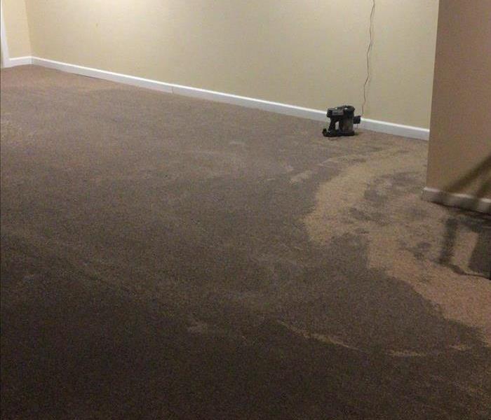 Finished basement with wet carpet